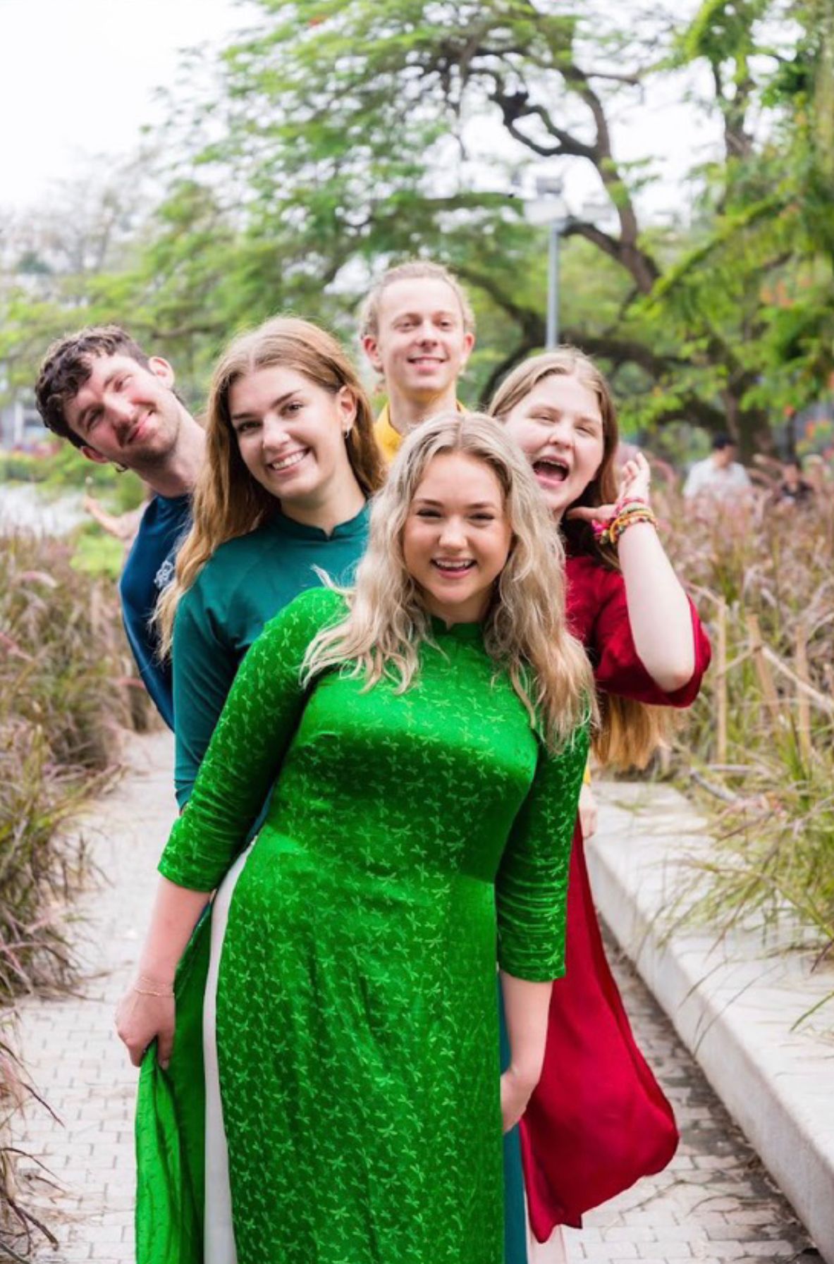 Cohort wearing traditional áo dài in a Hanoi park